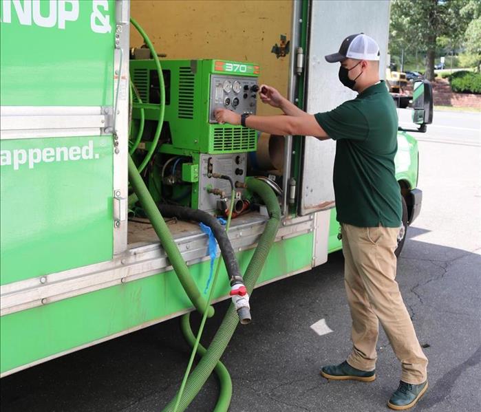 Man adjusts equipment in a truck
