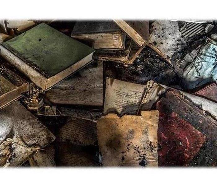 A pile of damaged documents and books