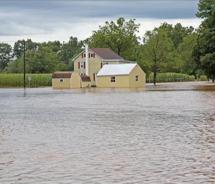 A house is surrounded by floodwaters