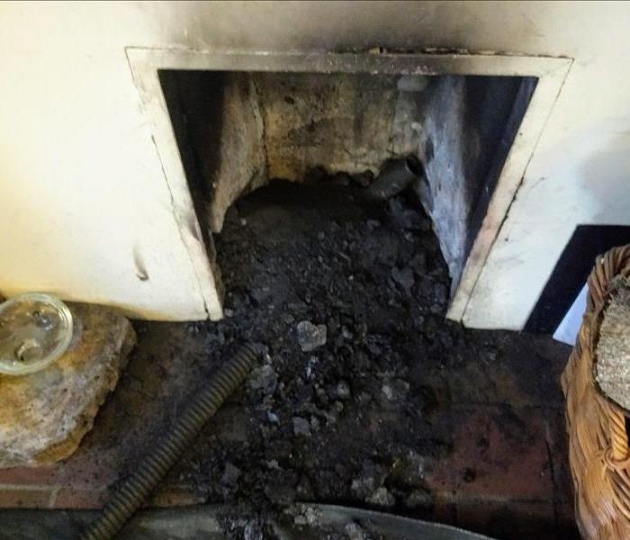 A fireplace is covered in soot