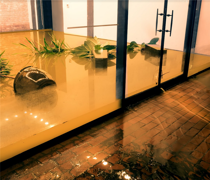 a flooded room with water leaking in from outside