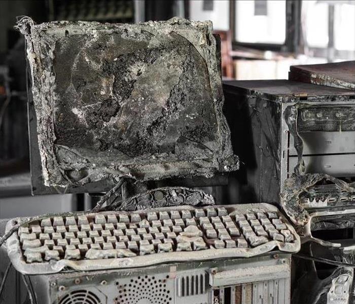A burned desktop computer and monitor