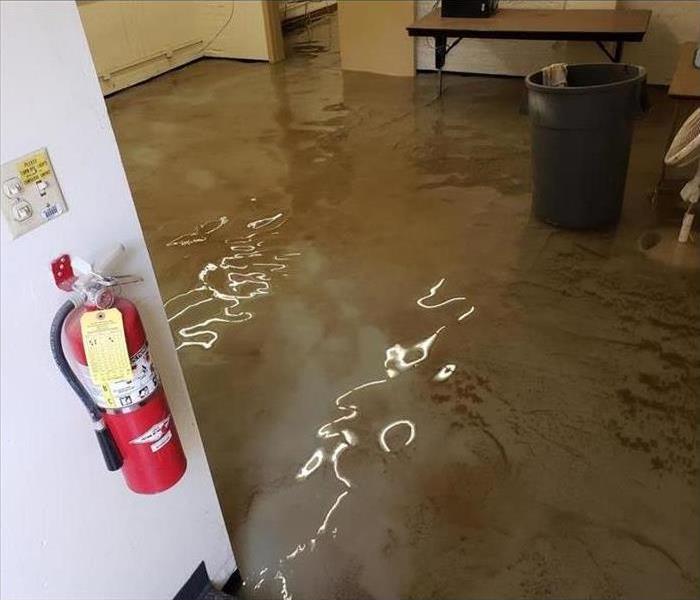 A flooded office with table and fire extinguisher