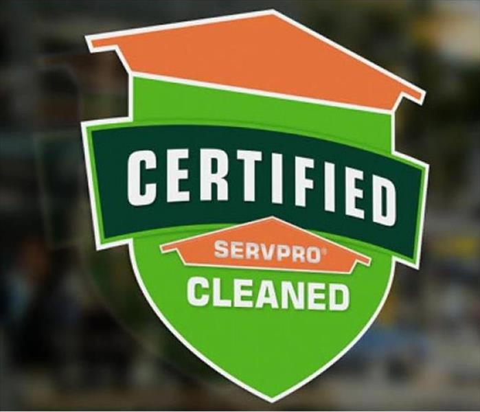 A Certified: SERVPRO Cleaned decal on the window of a business